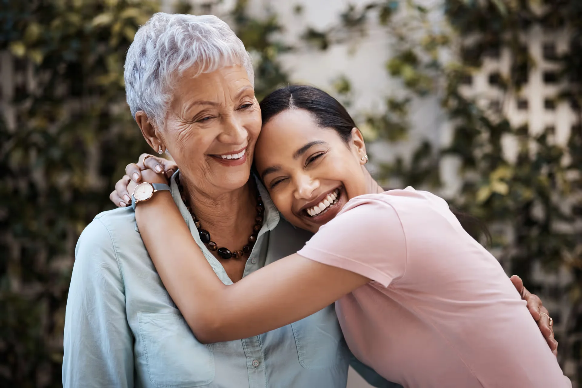 Two women of different generations embracing and laughing